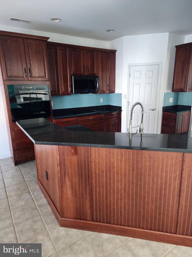 kitchen with oven, a sink, decorative backsplash, and light tile patterned flooring