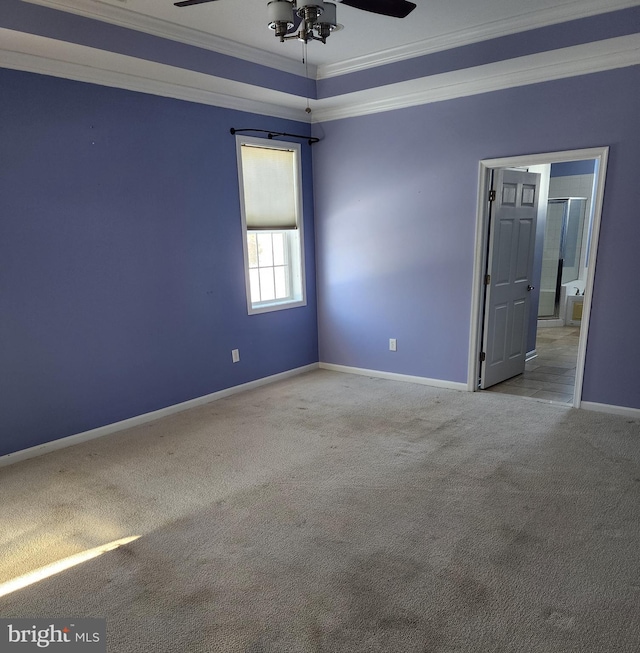 spare room featuring ornamental molding, light carpet, ceiling fan, and baseboards