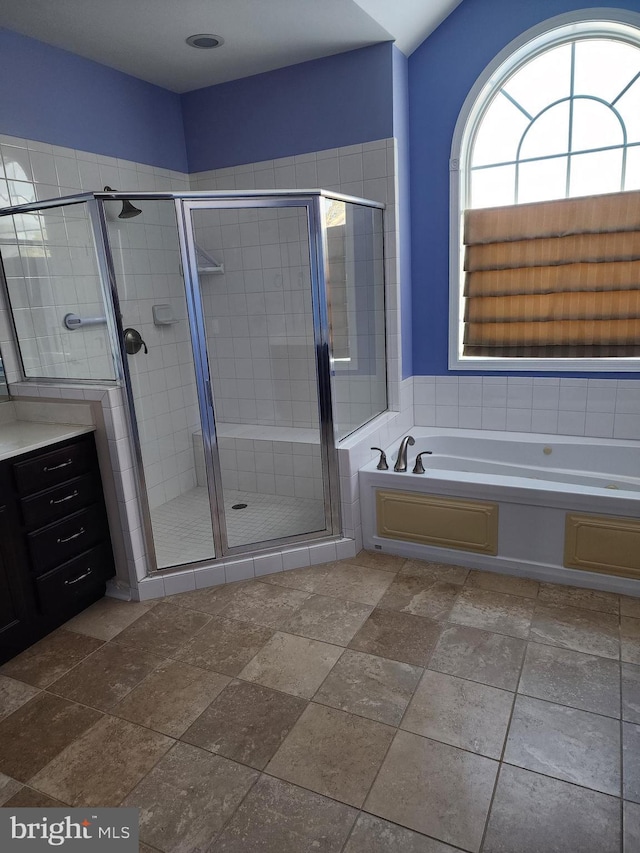 full bath with a stall shower and a garden tub