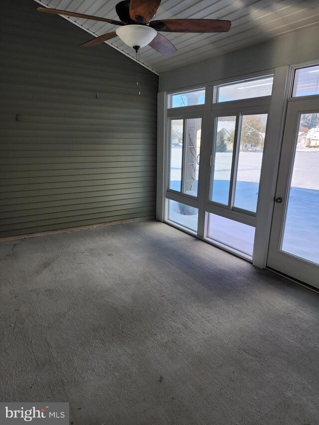 spare room with a water view, carpet, and a ceiling fan