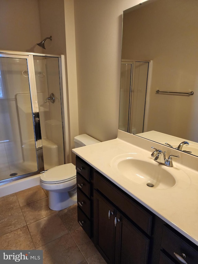 full bathroom with vanity, a shower stall, and toilet