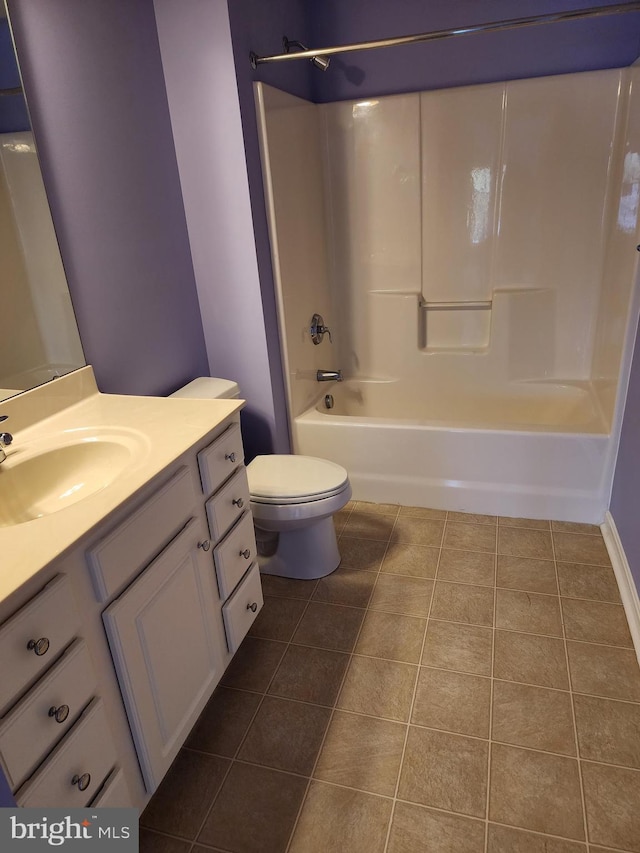 bathroom with toilet, tile patterned flooring, shower / tub combination, and vanity