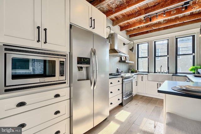 kitchen with sink, stainless steel appliances, beamed ceiling, ventilation hood, and brick ceiling