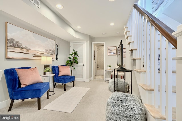 living area with light colored carpet