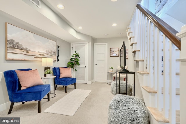 sitting room featuring light colored carpet