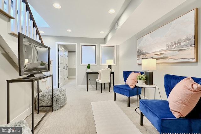 sitting room with light colored carpet