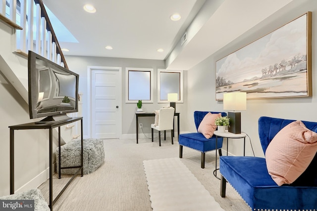 living area featuring light colored carpet