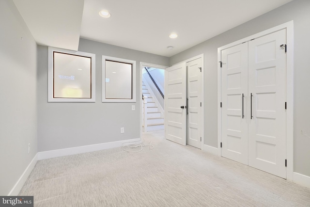 basement featuring light colored carpet