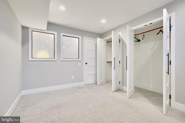 unfurnished bedroom with light colored carpet