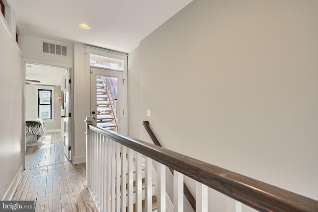 corridor with light hardwood / wood-style flooring