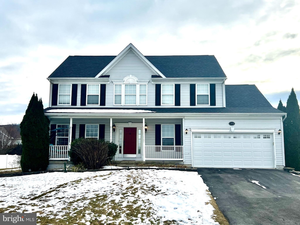 view of front facade with a garage and a porch