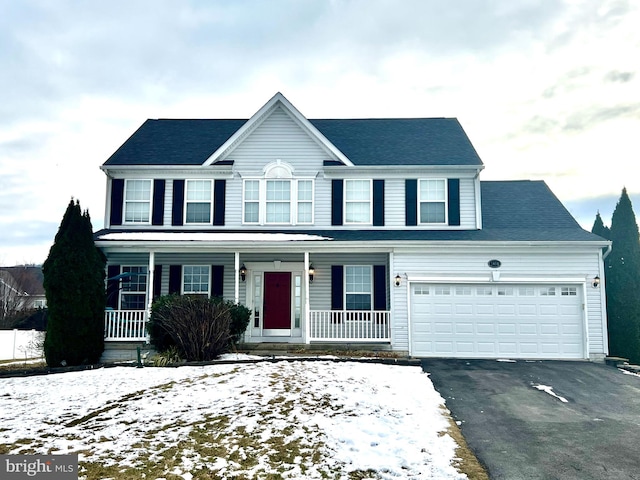 view of front facade featuring a porch and a garage