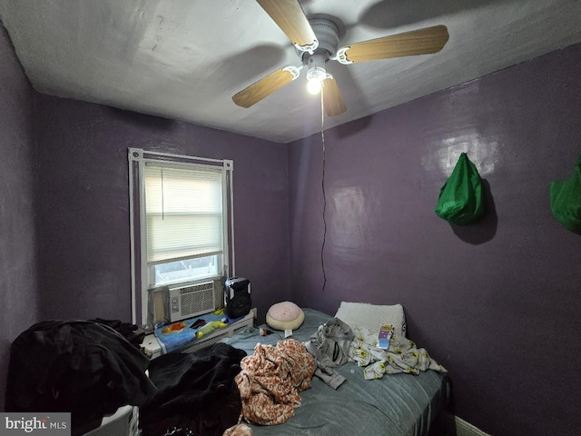 bedroom with ceiling fan and cooling unit