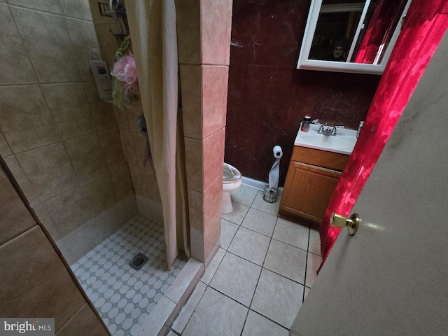 bathroom with curtained shower, tile patterned flooring, vanity, and toilet