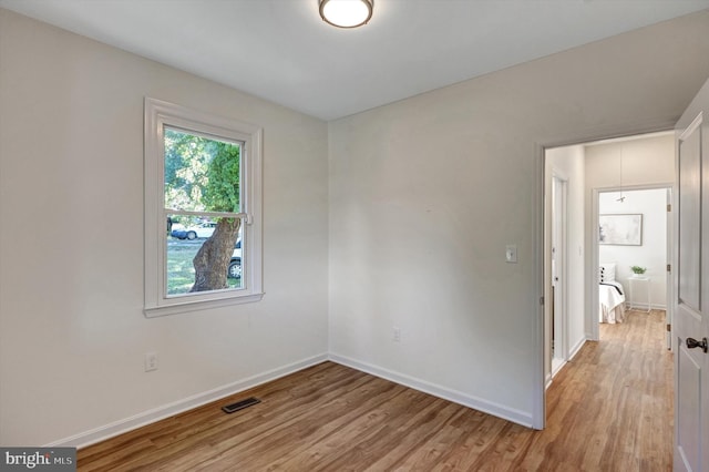 spare room with light wood-type flooring