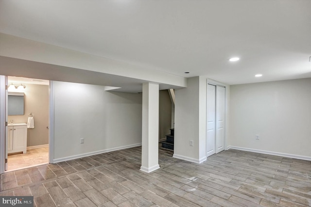 basement with light hardwood / wood-style flooring