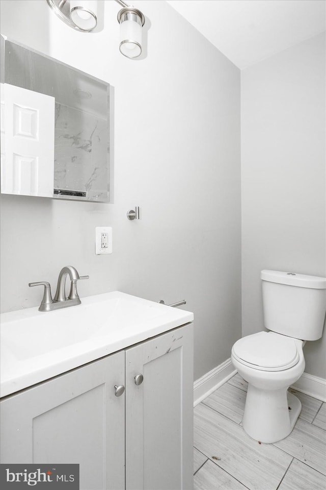 bathroom featuring toilet and vanity