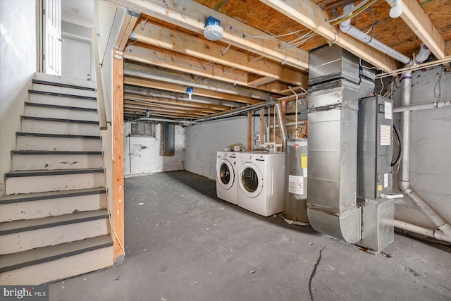 basement featuring water heater and washing machine and clothes dryer