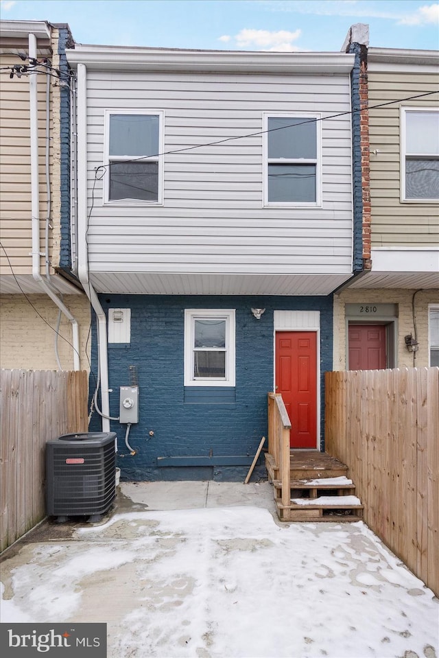 back of house with central AC unit