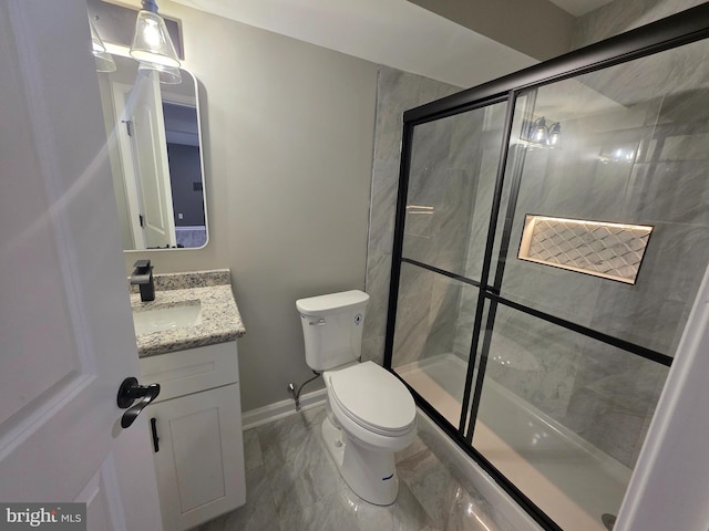 full bath featuring toilet, vanity, baseboards, marble finish floor, and a stall shower