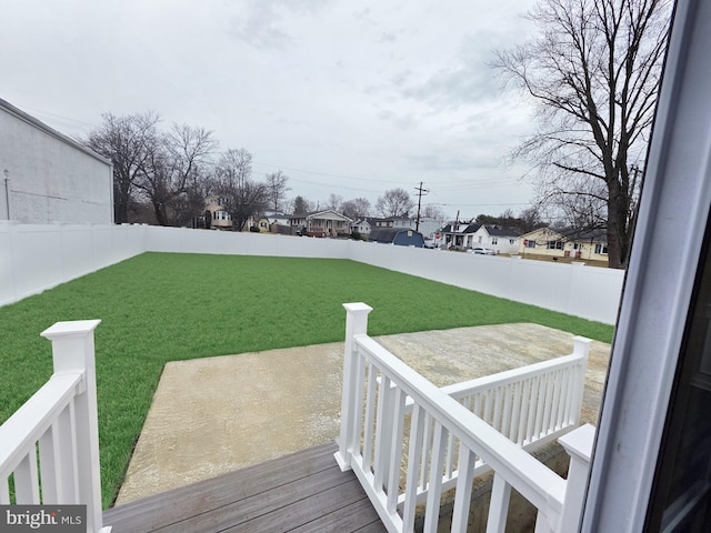 deck featuring a fenced backyard and a yard