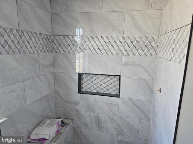 bathroom with a tile shower