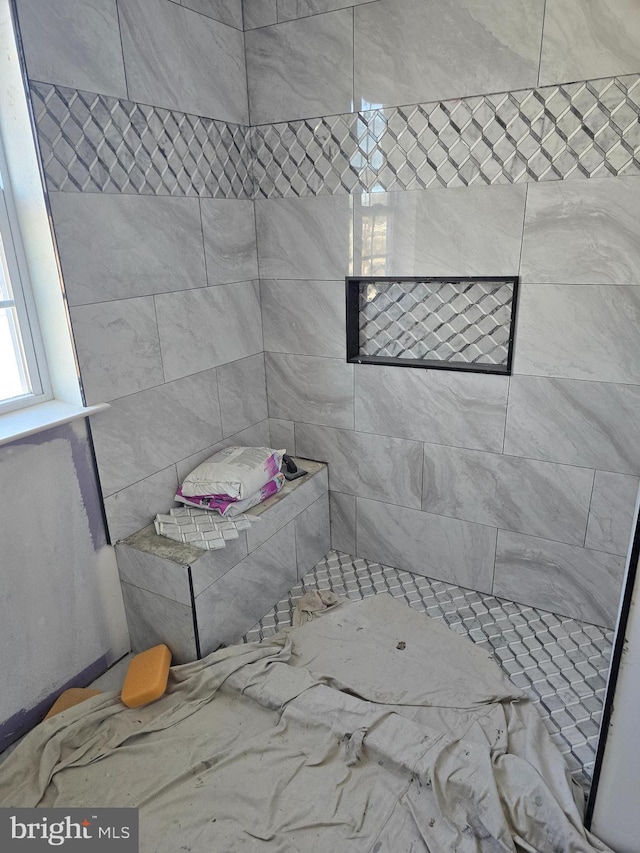 bathroom with tiled shower