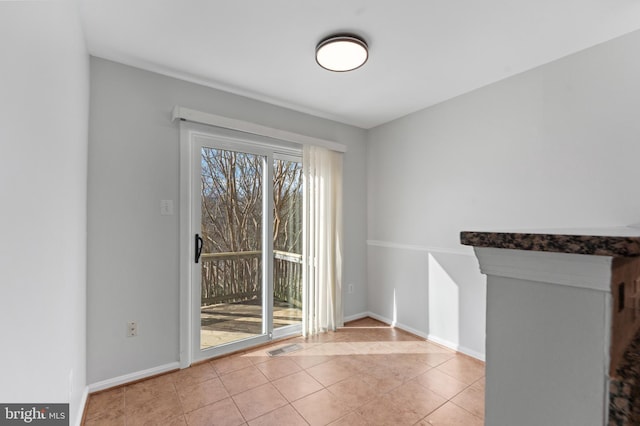 unfurnished dining area featuring visible vents, baseboards, and tile patterned floors