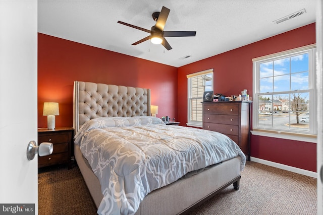 bedroom featuring carpet, baseboards, visible vents, and a ceiling fan