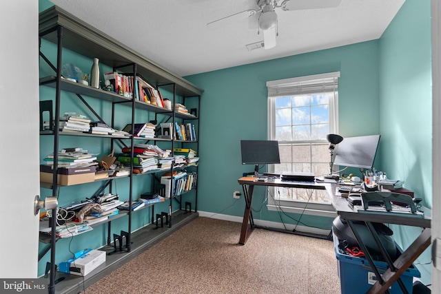 office space featuring carpet floors, baseboards, and a ceiling fan