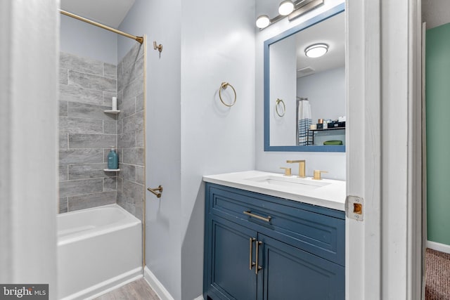 bathroom featuring shower / tub combo, vanity, and baseboards