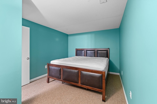 carpeted bedroom with visible vents and baseboards