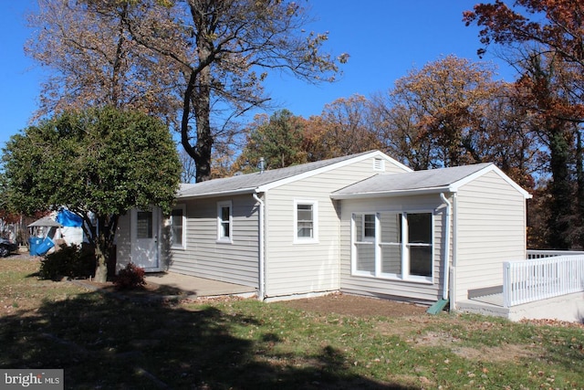 view of property exterior with a yard