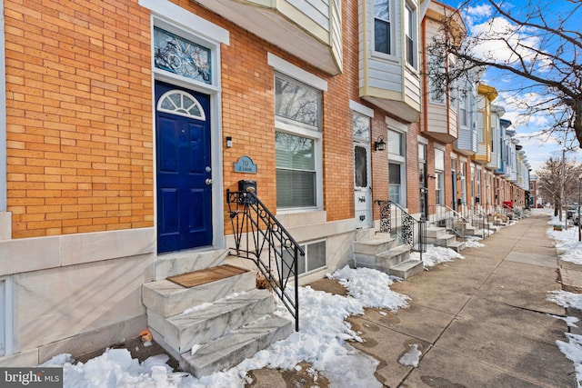 view of snow covered property entrance