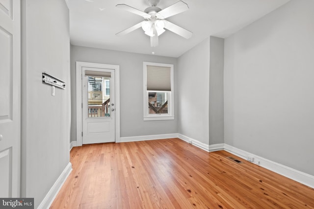 empty room featuring ceiling fan and light hardwood / wood-style flooring