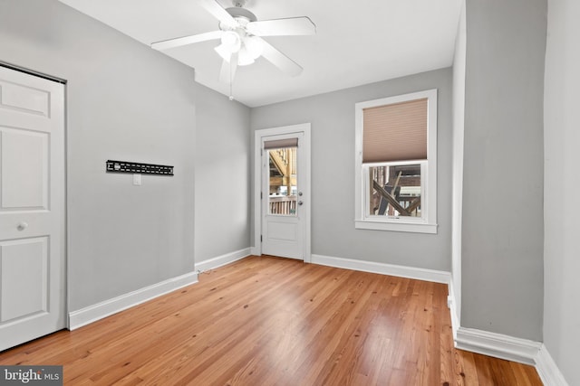 empty room featuring light wood-type flooring and ceiling fan