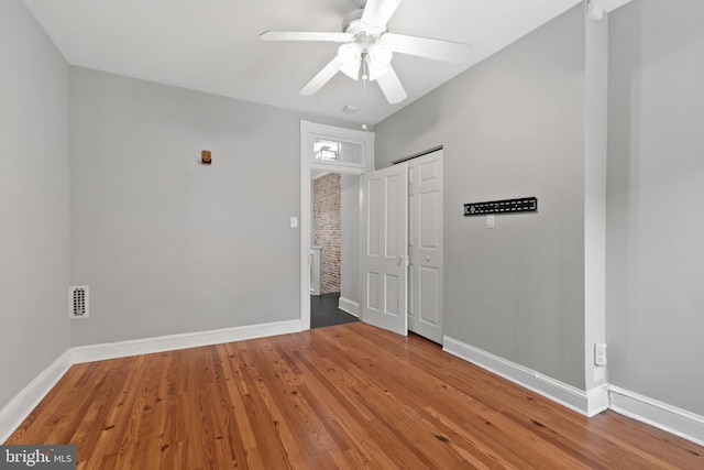 unfurnished room with hardwood / wood-style flooring and ceiling fan