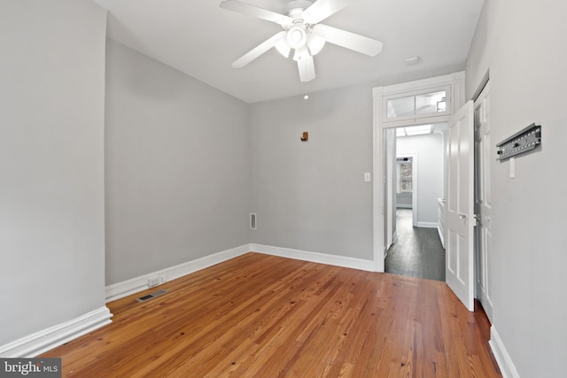 spare room featuring wood-type flooring and ceiling fan