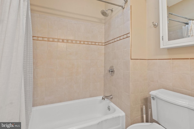 bathroom featuring shower / bath combo with shower curtain, tile walls, and toilet