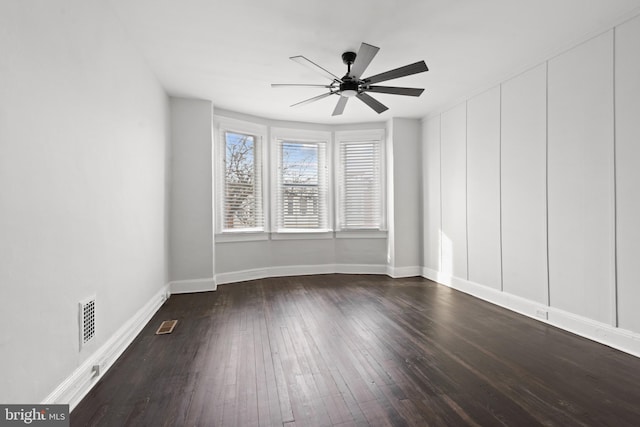 unfurnished room featuring ceiling fan and dark wood-type flooring