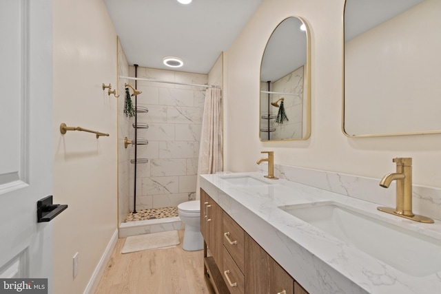 bathroom featuring a shower with curtain, vanity, hardwood / wood-style flooring, and toilet