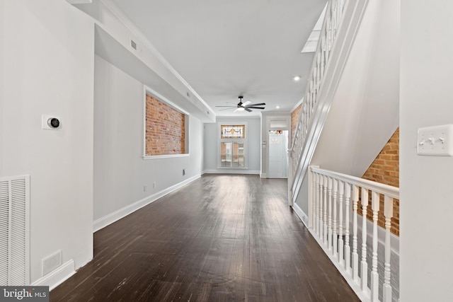 hall with ornamental molding and dark wood-type flooring