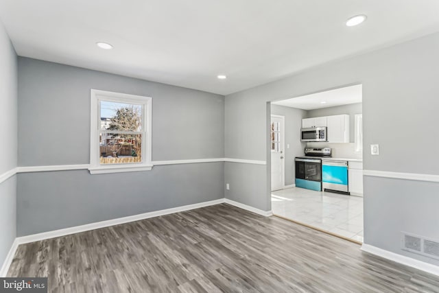 empty room with light hardwood / wood-style floors