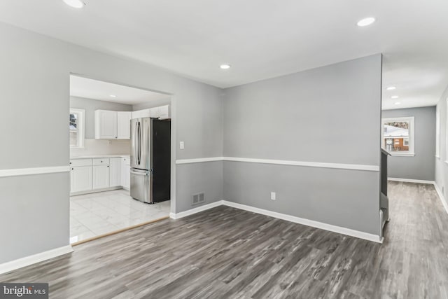 spare room with light wood-type flooring