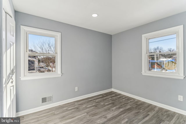 empty room with hardwood / wood-style flooring