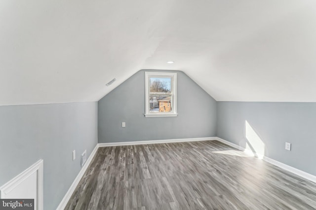 bonus room with lofted ceiling and wood-type flooring