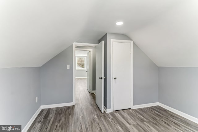 bonus room featuring vaulted ceiling and hardwood / wood-style floors