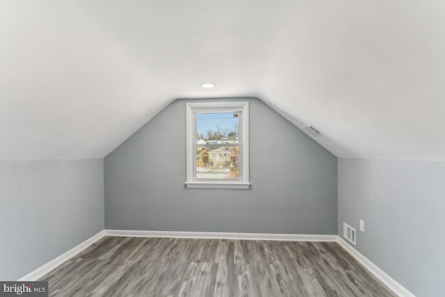 bonus room featuring wood-type flooring and lofted ceiling