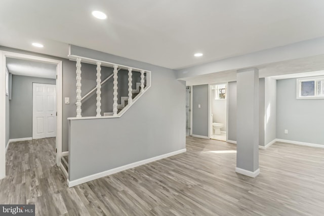 basement with light hardwood / wood-style floors