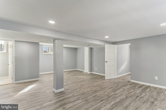 basement with light hardwood / wood-style floors